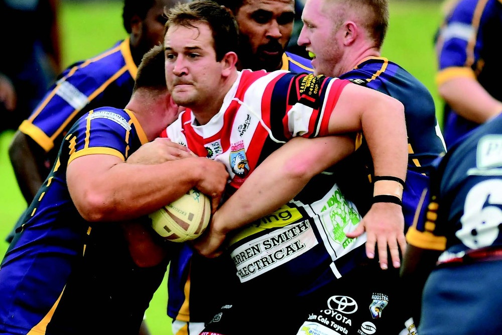 Roosters forward Anthony Curcio is claimed by the Edmonton Storm defence on Saturday night.