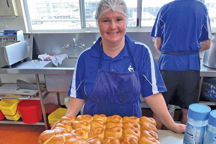Atherton District Meals on Wheels volunteer Susan Walters with freshly baked rolls for clients throughout the Tablelands region. Susan is a regular volunteer and enjoys her time helping the community.