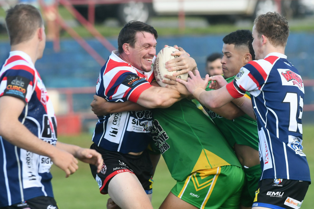 Roosters fullback Nick Pratten forces his way through the Mareeba defence on Sunday.