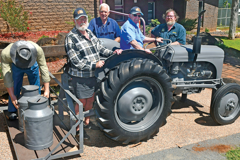Malanda Men’s Shed members Jeff Brown, John Warren and Ray Copeland with Central Tyre service Malanda manager Steve Wallace, who donated the tractor tyres, at the recently refurbished Malanda Dairy Sculpture.