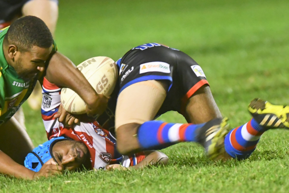 Roosters Jermaine Pedro is stopped by the Gladiators defence on Saturday night.