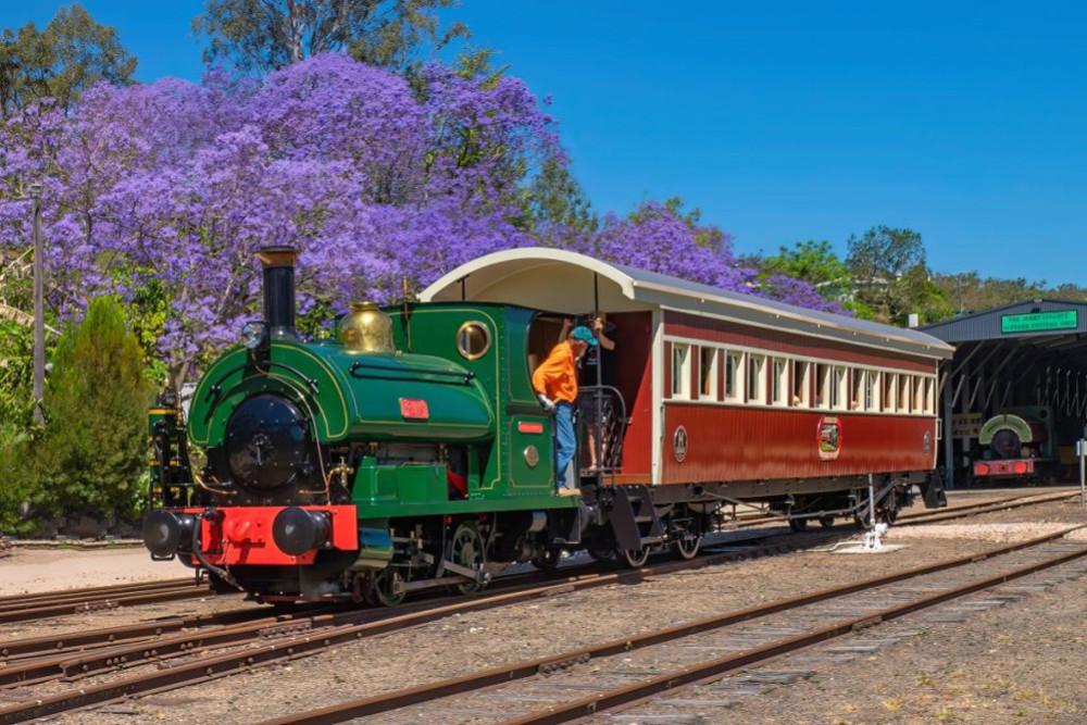 The award winning 1905 Peckett steam locomotive pulling the restored 1913 wooden carriage at Herberton Station. IMAGE: Trevor Duncan.