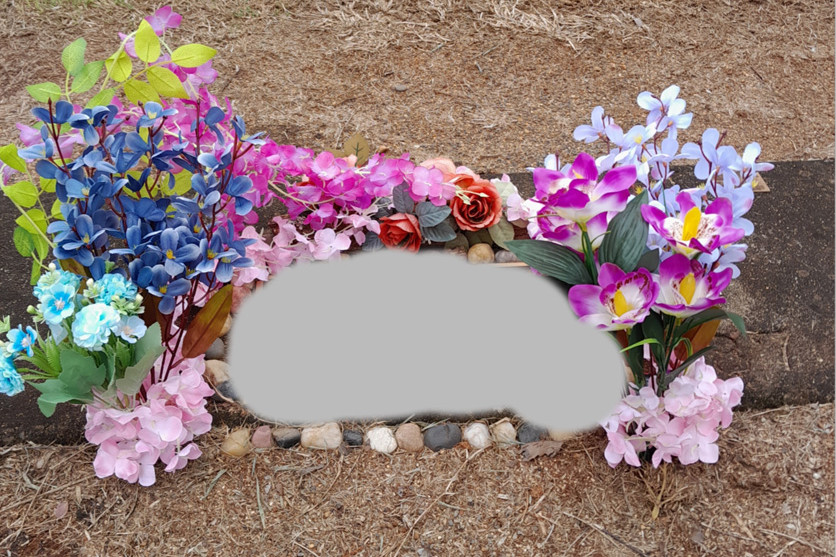 The mother’s grave before the attack where all the items were removed.