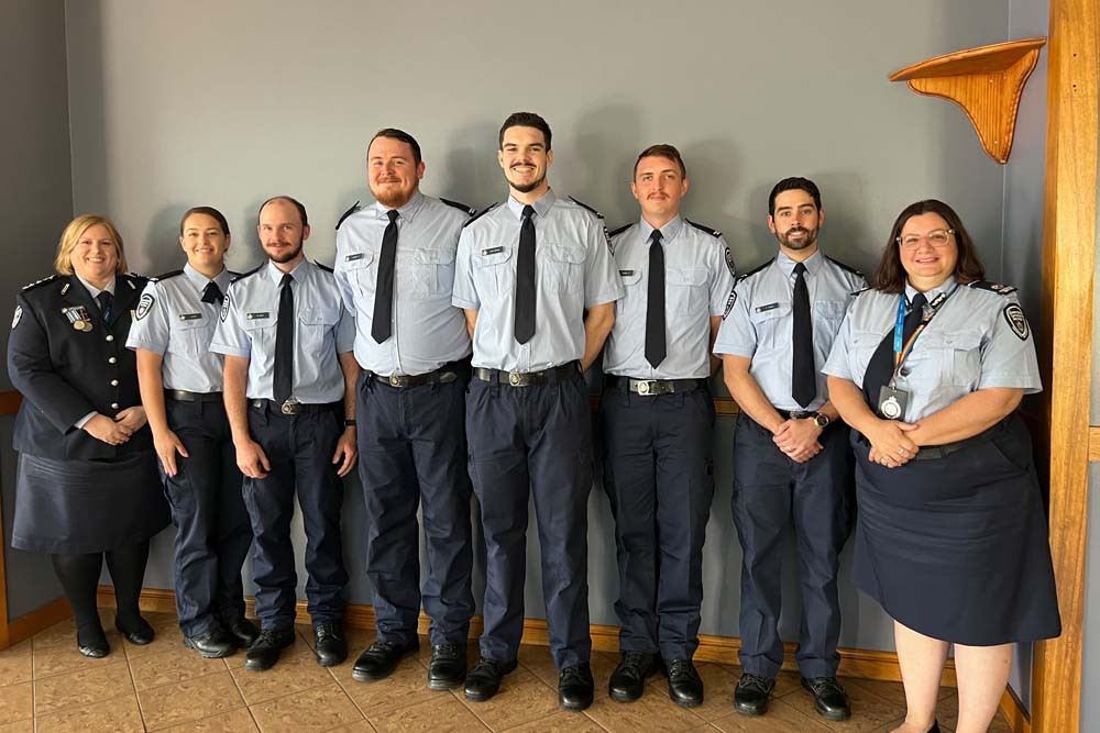 Lotus Glen general manager Chief Superintendent Gabrielle Payne ACM (left) with the nine new graduates and Queensland Corrective Services Assistant Commissioner, Central and Northern Region Command, Eloise Hamlett ACM (right).
