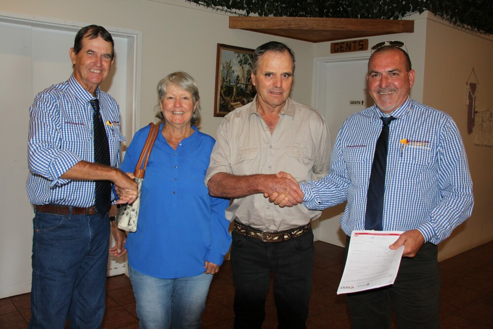 Queensland Rural's Auctioneer, Jacko Shephard (left) and Rural Property and Livestock Specialist, Scott Hart (right), congratulate vendors Odette and Steve Plozza on the benchmark sale of their Malanda biodynamic property, "Waratah”.