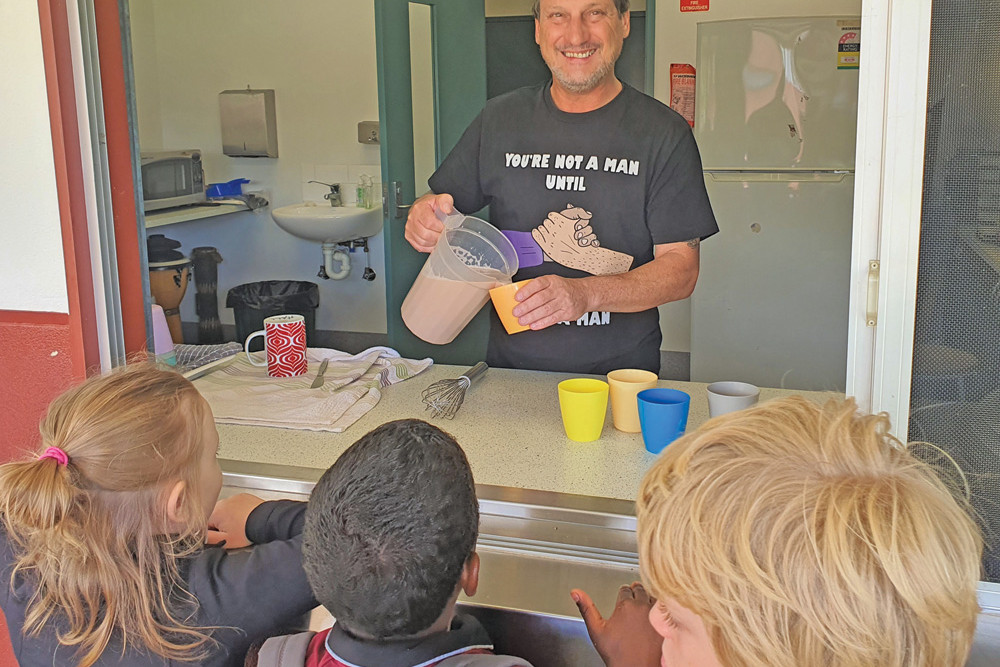 Ken Carey serving up breakfast to students at Ravenshoe State School