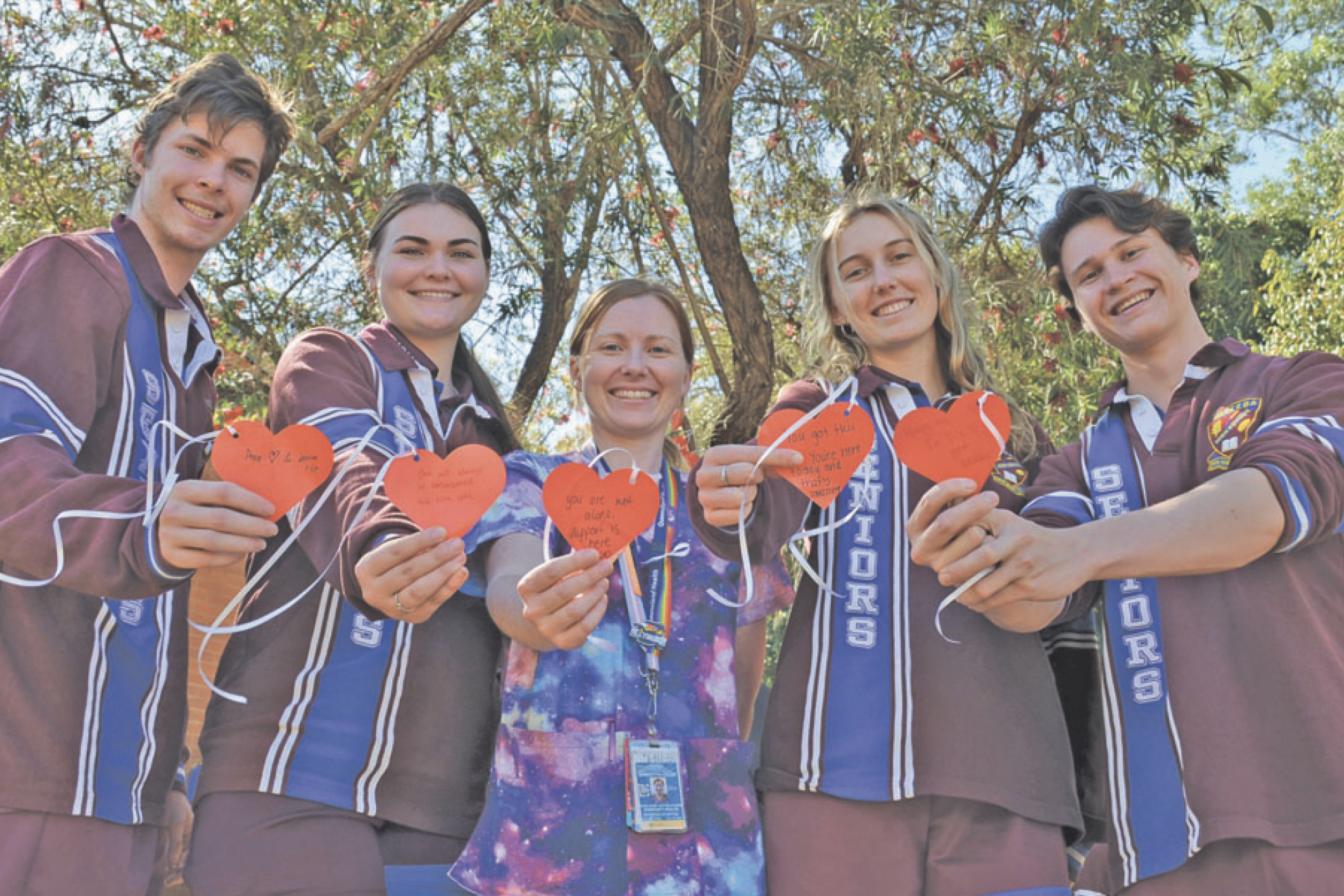 PLEDGE NO: Lachlan Costa, Kelli Scott, school nurse Samantha Hales, Cassia James and Jack Fealy all hung a heart on Kelly's memorial tree last week.