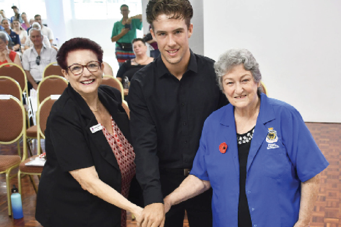 Mayor Angela Toppin cuts the Australia Day cake with Junior Citizen of the Year Steven Young and Citizen of the Year Cheryl Emmerson.