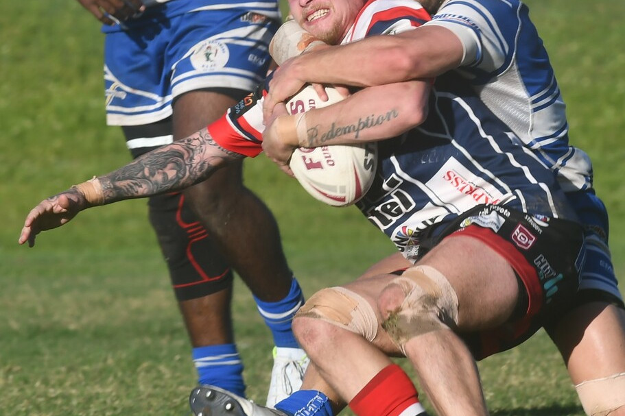 Atherton Roosters winger Jesse Carleton is claimed by the Brothers defence on Sunday.