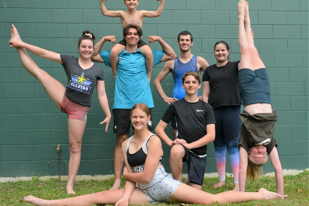 Mareeba gymnasts Dayna Pearce, Frank Tulloch, Kip Fealy (on shoulders), Andrew Hawthron, Emma Hawthron, Ryan Pearce (kneeling), Lexi Fealy (doing splits) and Lizzy MacLaughlin (hand standing) are heading to Amsterdam next year.