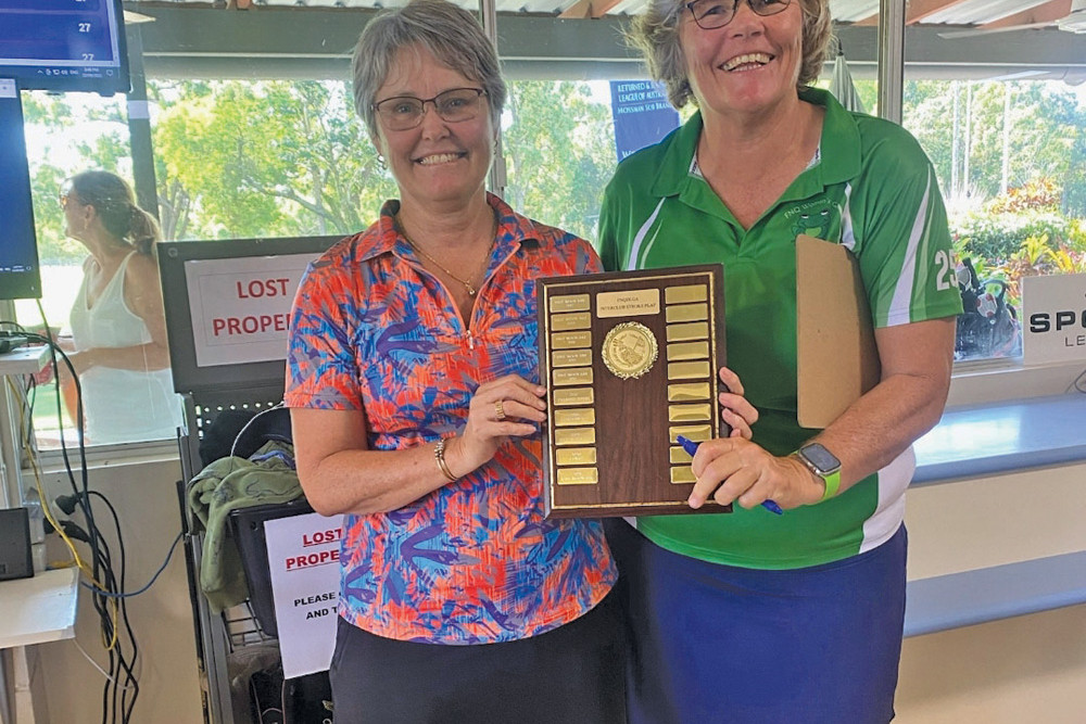 FNQ women’s golf president Niki Bruce presenting Atherton Golf Club ladies captain Shelley Broadley with their trophy.