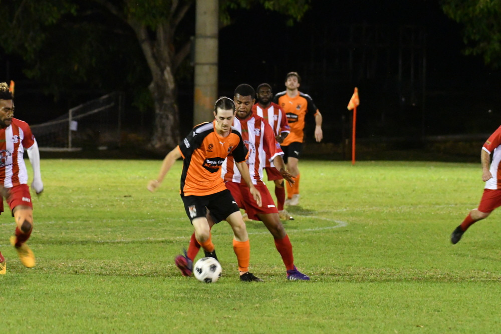 Midfielder Liam Pozzebon tries to punch his way through Innisfail’s defense during their match on Saturday night.