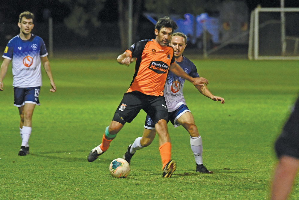 Mareeba Bulls Premier Men’s midfielder Wayne Srhoj passing back during the team’s 2-1 win over the Marlin Coast Rangers on Saturday night.