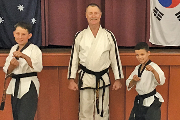 Xtrheem Tae Kwon-do master instructor Phil Quayle with fresh junior black belts Jack Pownall-Teece and Tian Schutte.