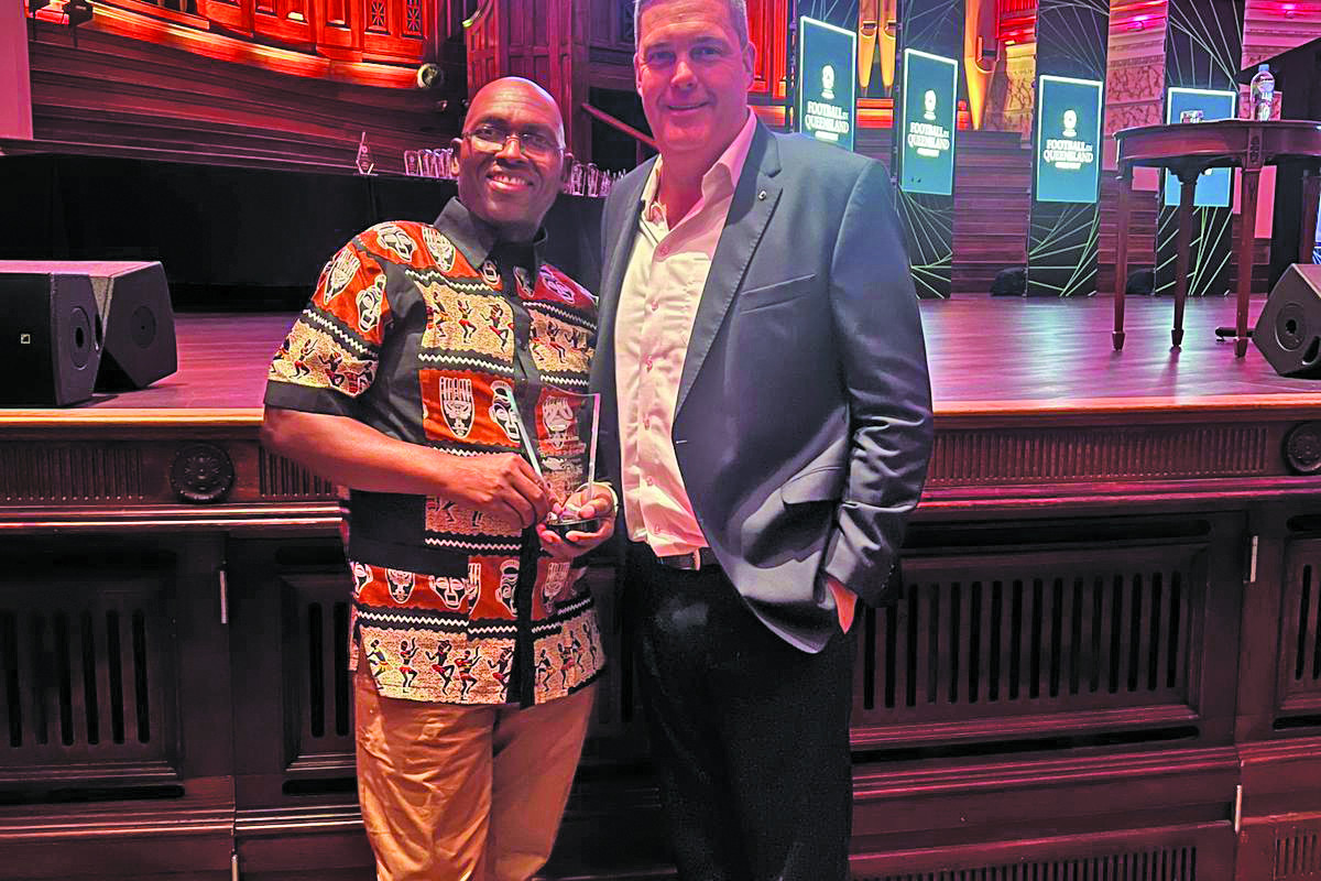 Eagles Under 13 coach Johnson Makoti and FNQ Zone Manager Alex Srhoj at the Football Queensland awards ceremony.