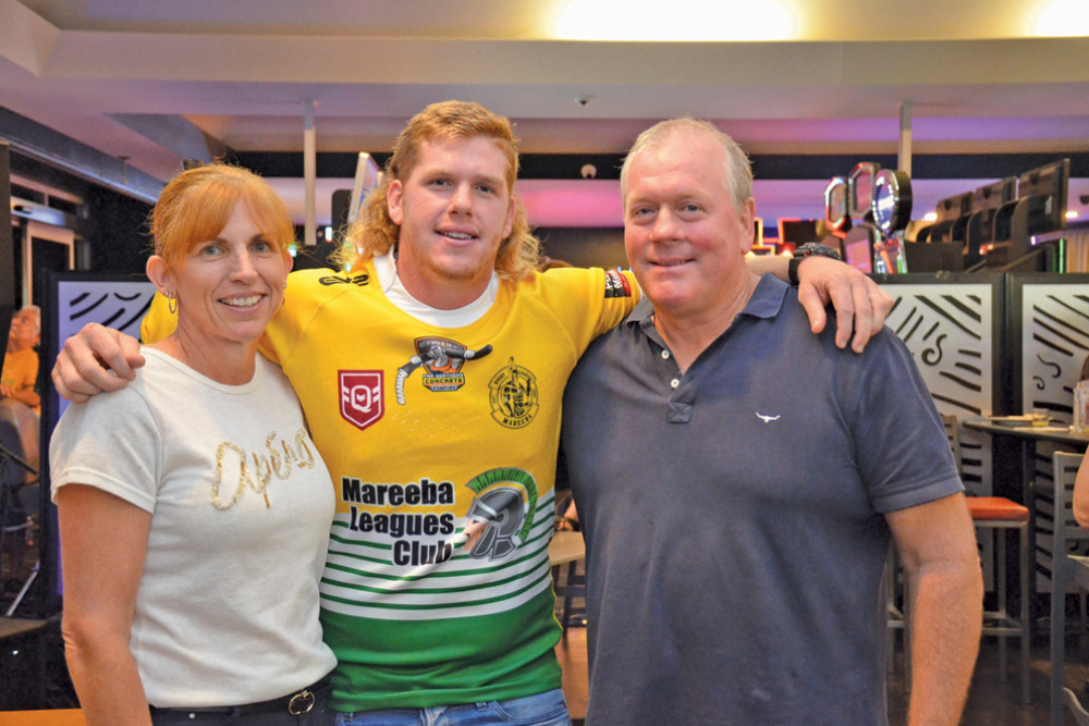 Greg and Sandra Flegler from CTR Bananas bid a massive $5,100 for the number 9 jersey worn by their son Ryan (centre)