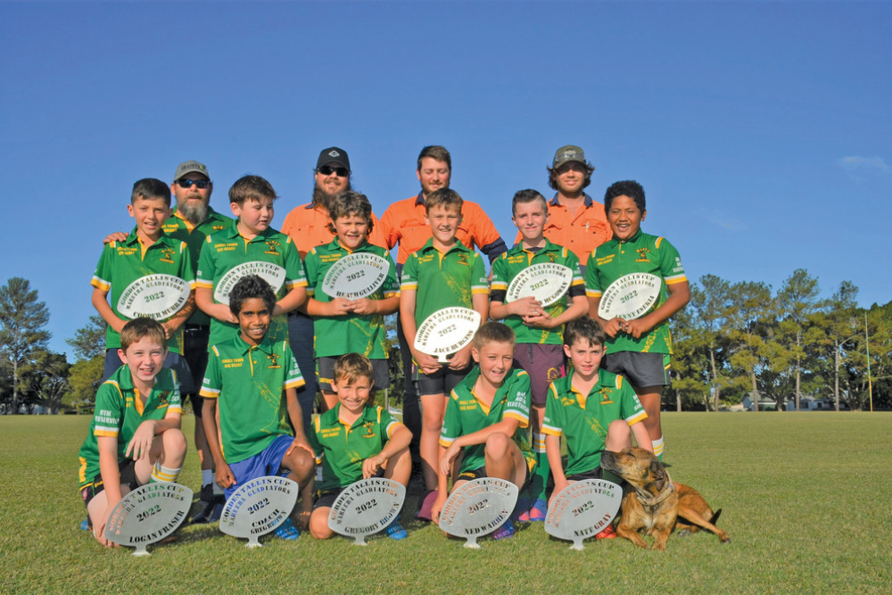 The team from Granite Engineering and Manufacturing (back) designed and donated trophies to the Mareeba Junior Rugby League U10’s team to recognise their efforts at the Gorden Tallis Cup.