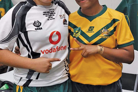 Mareeba’s May May Hobbler (left) after she exchanged jerseys with a Fijian player after the match