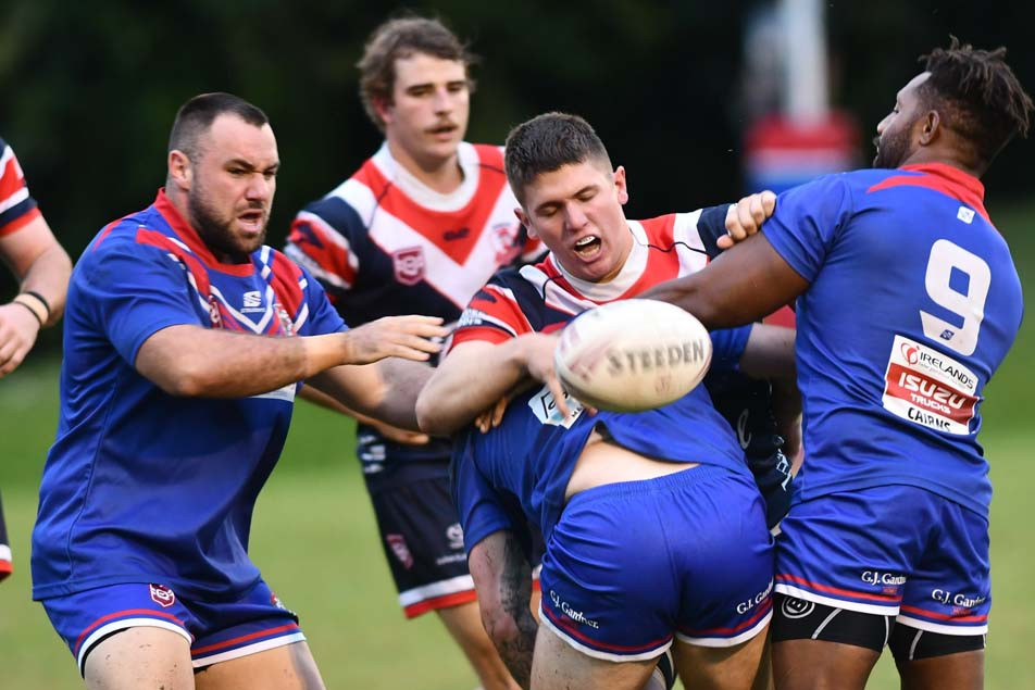 Roosters forward Riley Flute is caught by the Ivanhoes defence at Smithfield on Saturday.