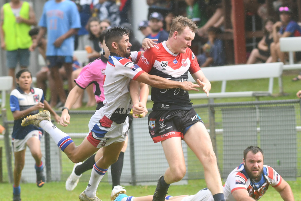 Roosters winger Tom Cuda caught by the Ivanhoes de-fence at Smithfield on Sunday