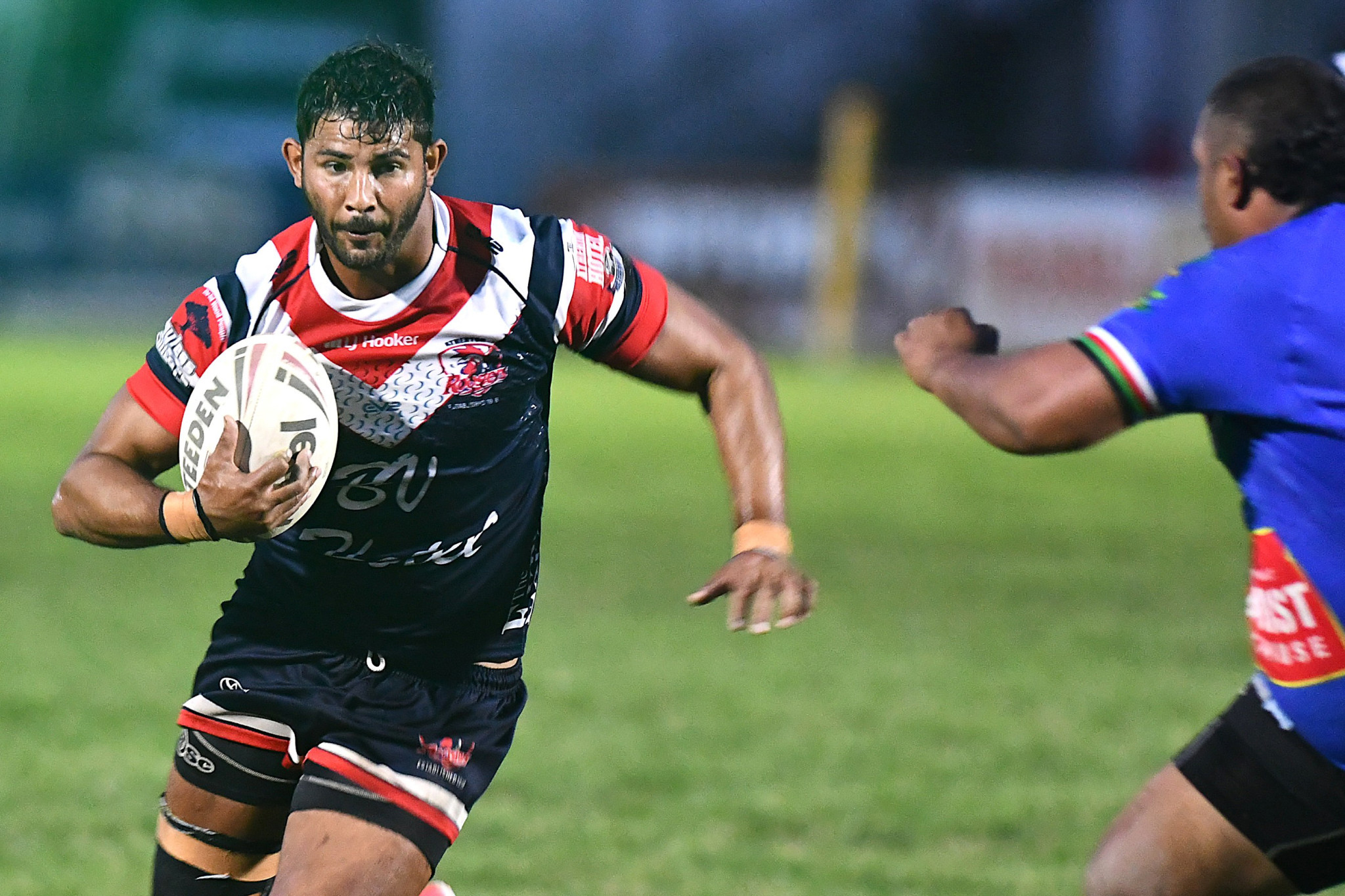 Roosters prop James Clark takes a hit up.