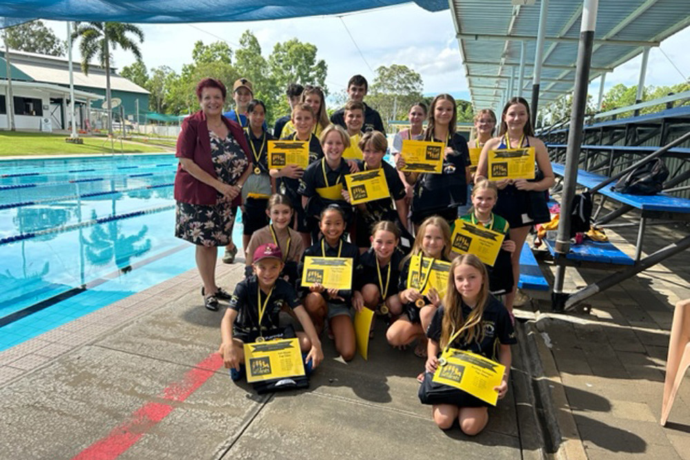 Mareeba Mayor Angela Toppin with swimmers after receiving their participation medals and towels