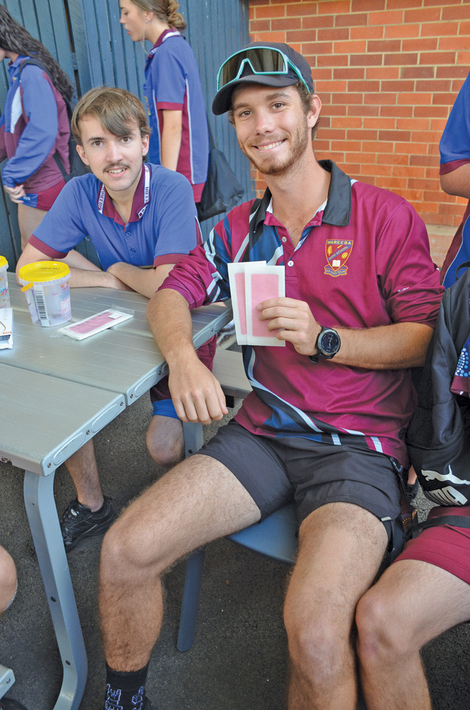 Mareeba high student Matthew Heggie with teacher Travis Cummings who waxed his legs and shaved his head for the cause.