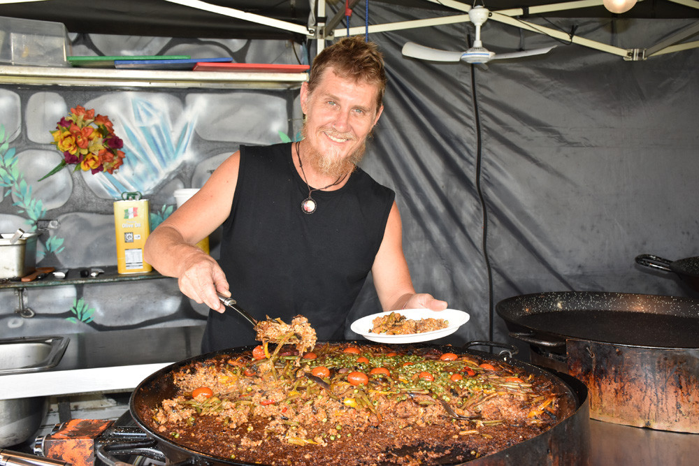 East Coast Paella owner and head chef Scotty Osborne dishing up some authentic Spanish Paella for some hungry customers.