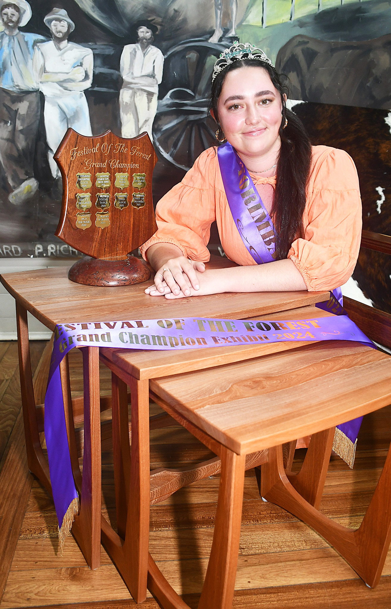 2023 Torimba queen Clairice Lucey with the grand champion exhibit at the Festival of the Forest display - nested tables entered by Phil Griffiths.