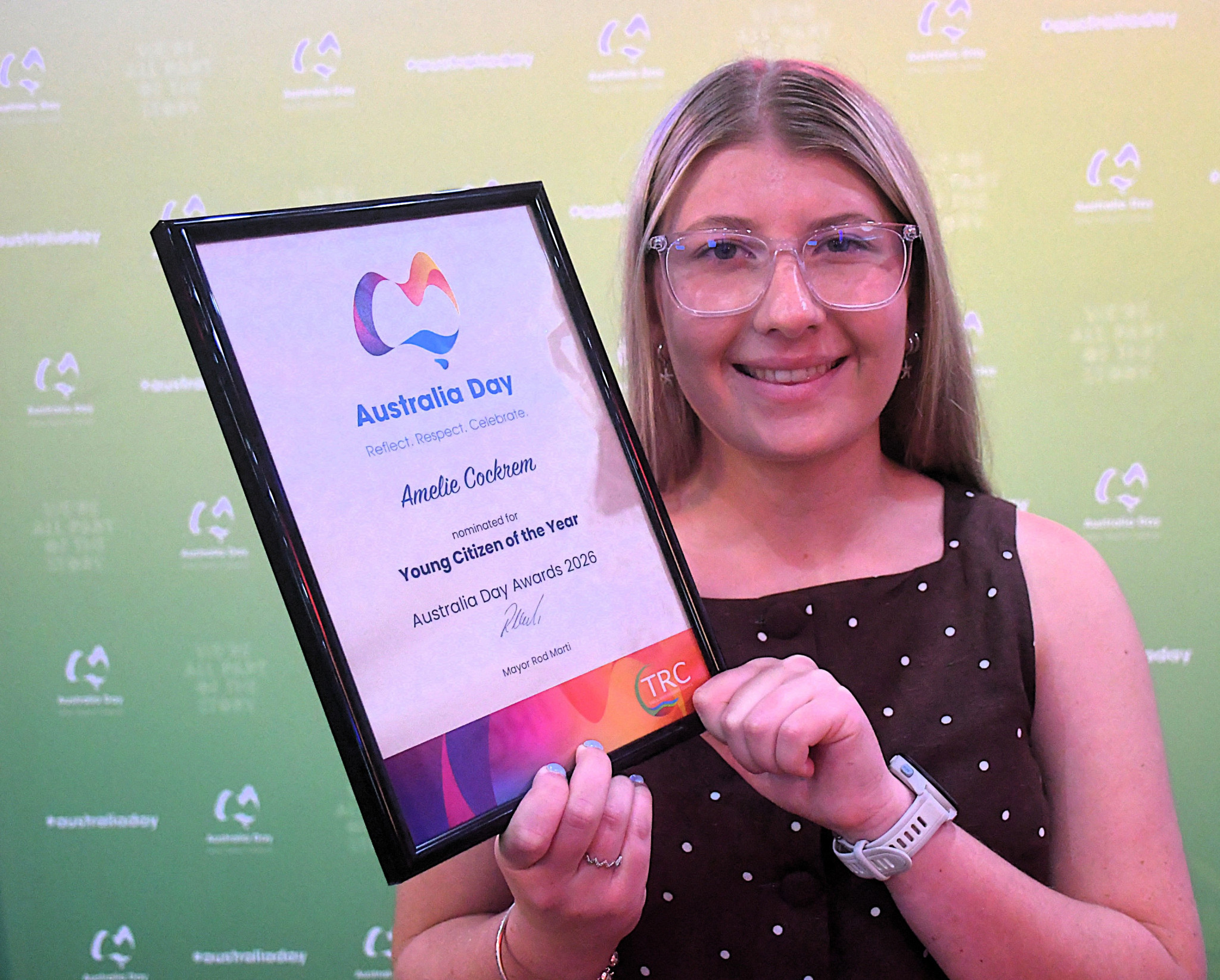 Amelie gives a big smile with her award.